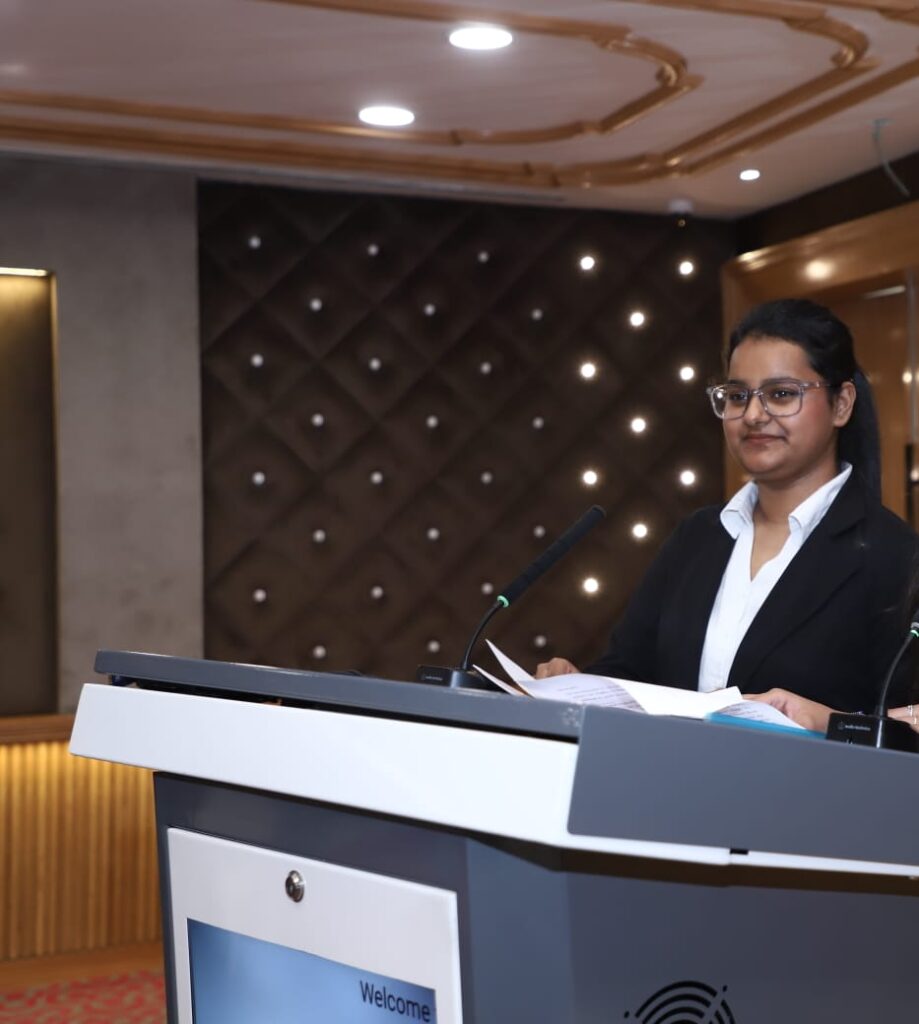 Ananyaa standing on a podium delivering speech